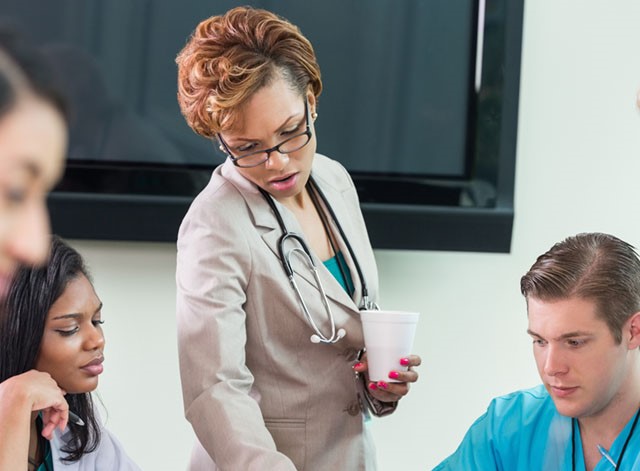 doctor and nurses around a table