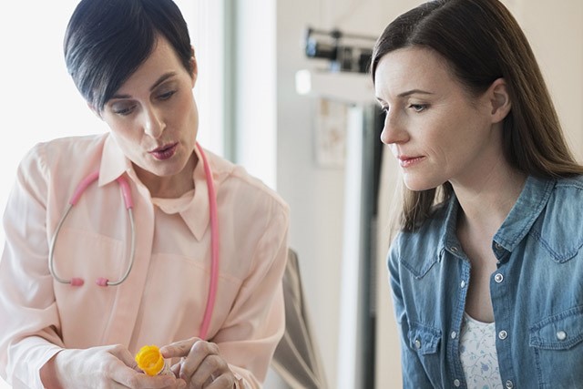 nurse with patient discussing medication