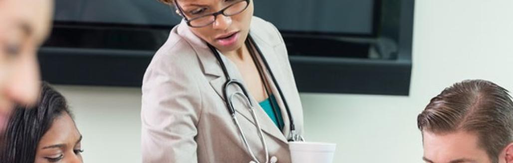 doctor and nurses around a table